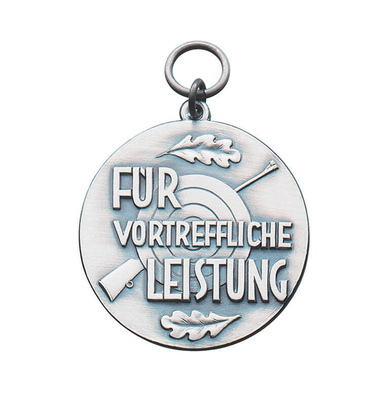 Medaille vergoldet für vortreffliche Leistung mit Schützenscheibe und Eichenlaub Runde Medaille vergoldet mit Öse und Ring, Schriftzug „Für vortreffliche Leistung“, Schützenscheibe, Gewehr und zwei Eichenlaubblättern als Motiv für besonders gute Schießleistung.