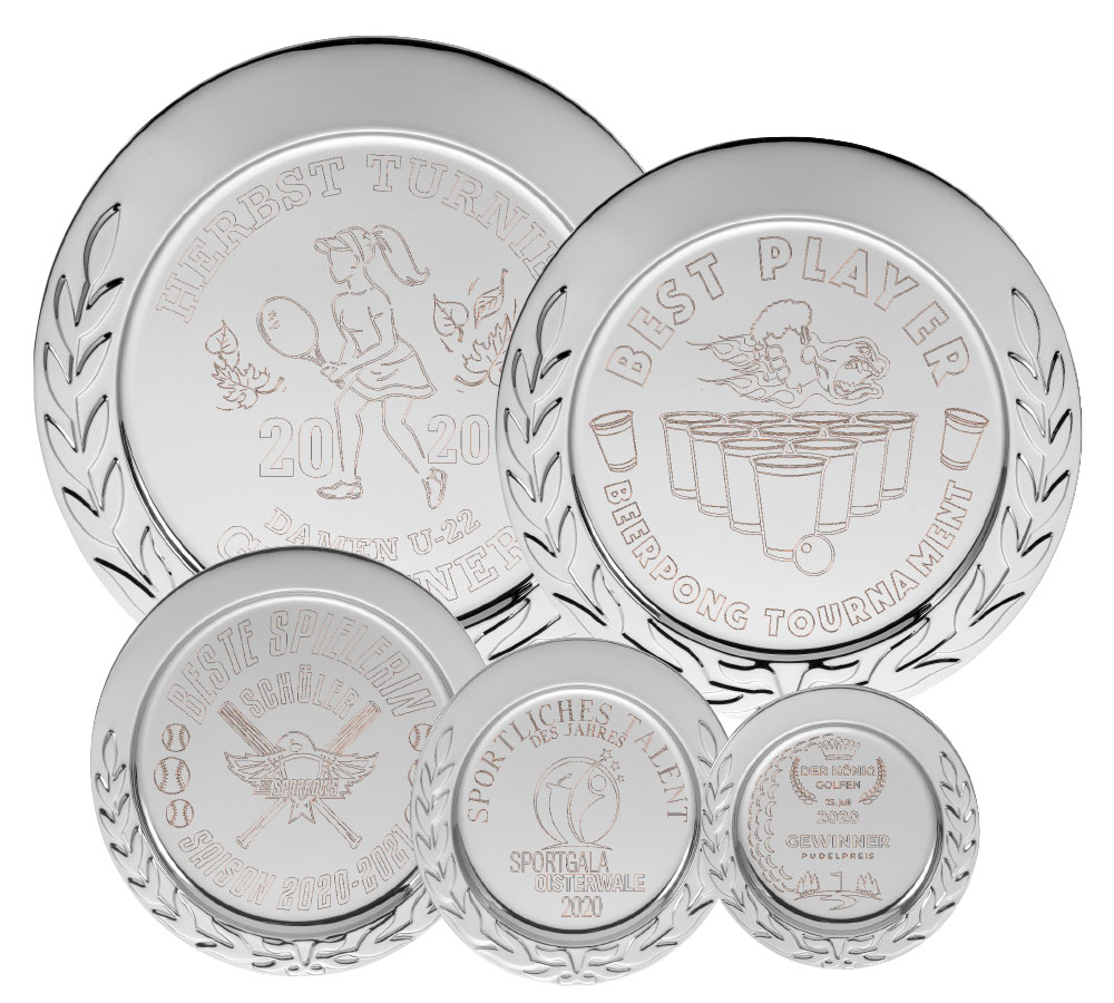 Ehrenteller „Ehrenkranz“ mit Gravur 100 mm, silberfarbener Teller mit Lorbeerkranzrand Mehrere silberfarbene Ehrenteller „Ehrenkranz“ mit Gravur in verschiedenen Größen, jeweils rund mit eingeprägtem Lorbeerkranz am Rand und unterschiedlichen Sportmotiven im Mittelteil